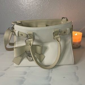 Cute! Claire’s white and light brown small purse w/ bow charm on the front